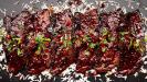 mediterranean-style pomegranate-glazed pork belly strips