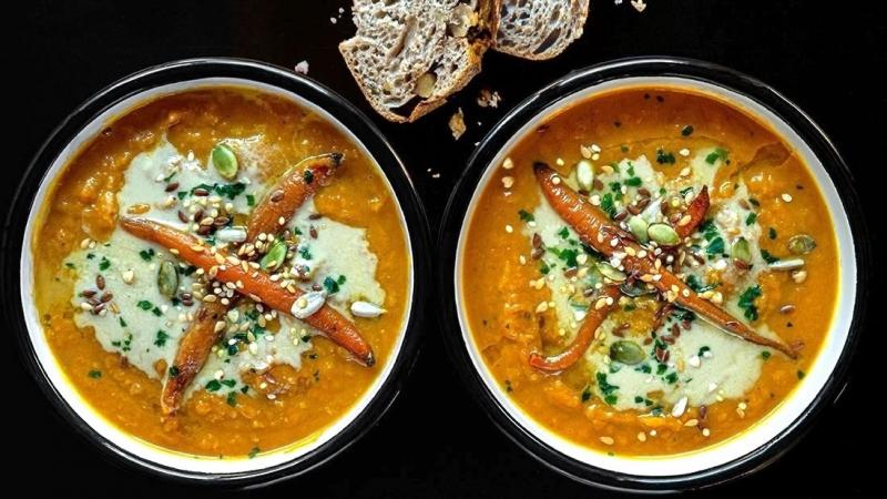 spiced carrot & sweet potato soup with tahini drizzle & seeds